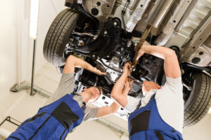 mechanics working under car